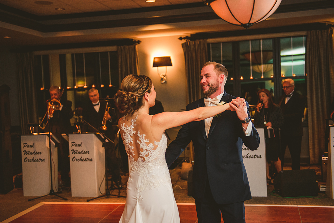 a bride and a groom dancing their first dance at the Cress Creek Country Club in Naperville as the Paul Windsor Orchestra plays in the background