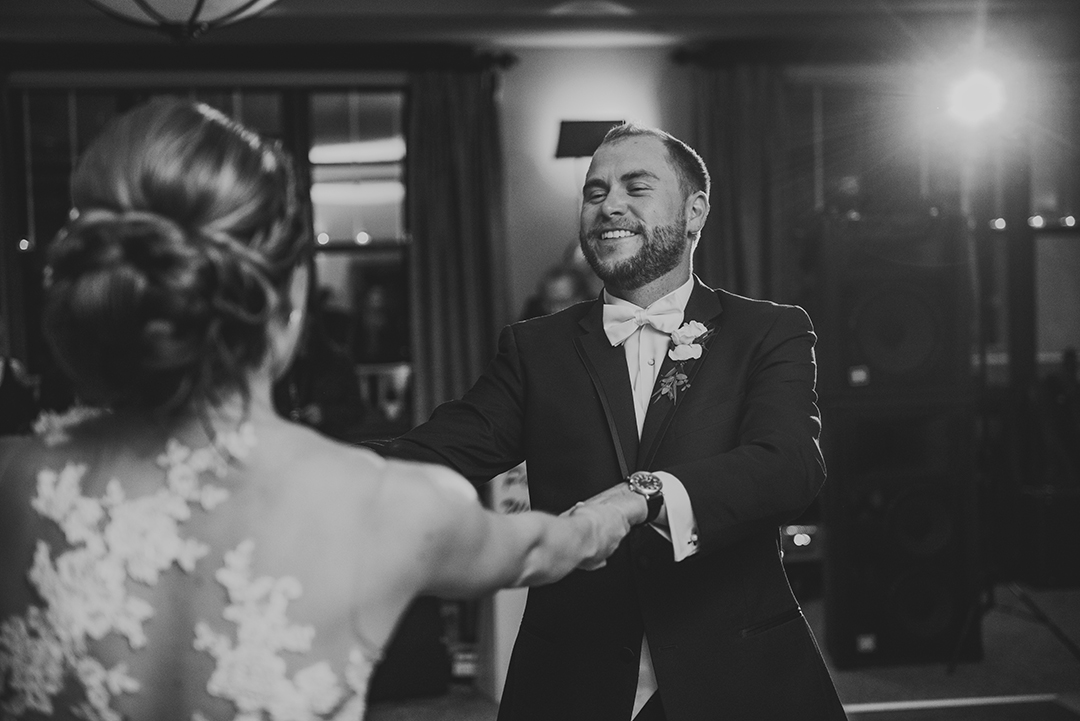 a groom spinning his bride during their first dance at the Cress Creek Country Club in Naperville