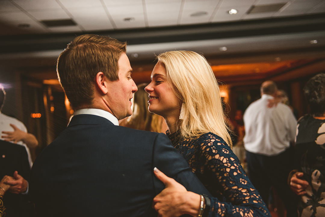 a woman smiling at her husband as they dance at a reception at the Cress Creek Country Club in Naperville