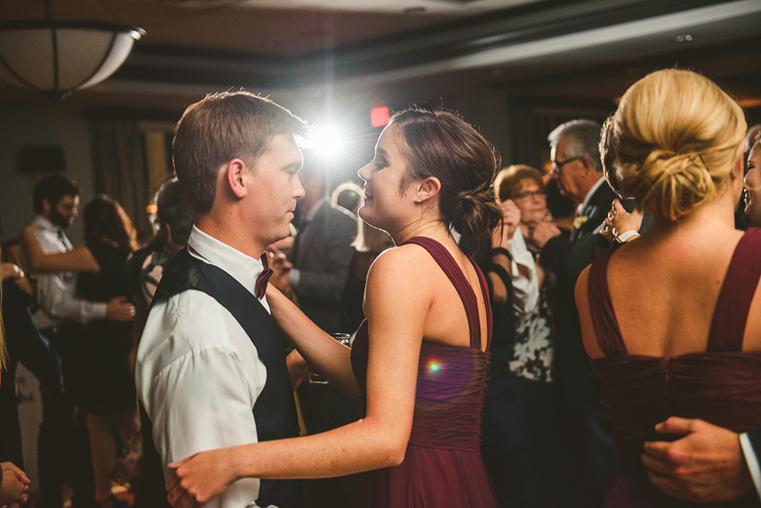 a bridesmaid and groomsman dancing during a reception at the Cress Creek Country Club in Naperville