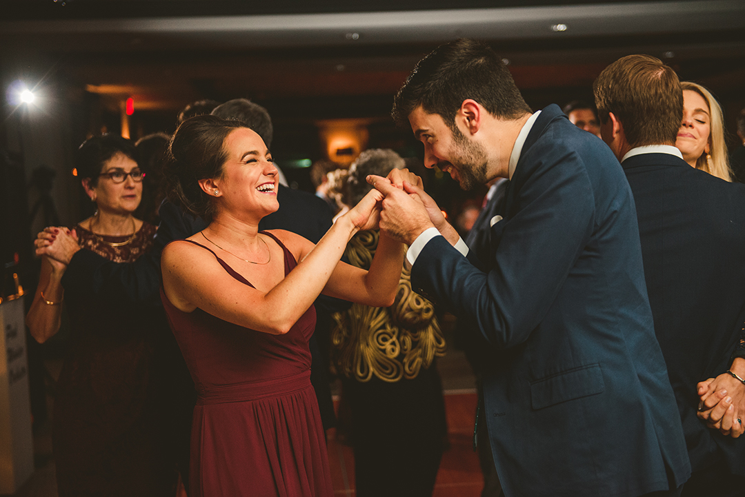 the maid of honor laughing at her husband as they dance at the Cress Creek Country Club in Naperville