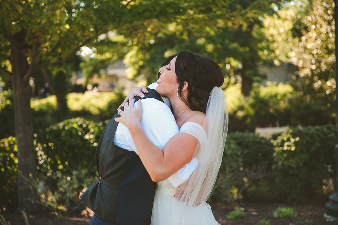 a bride hugging her groom after seeing each other for the first time at a park in Lockport IL