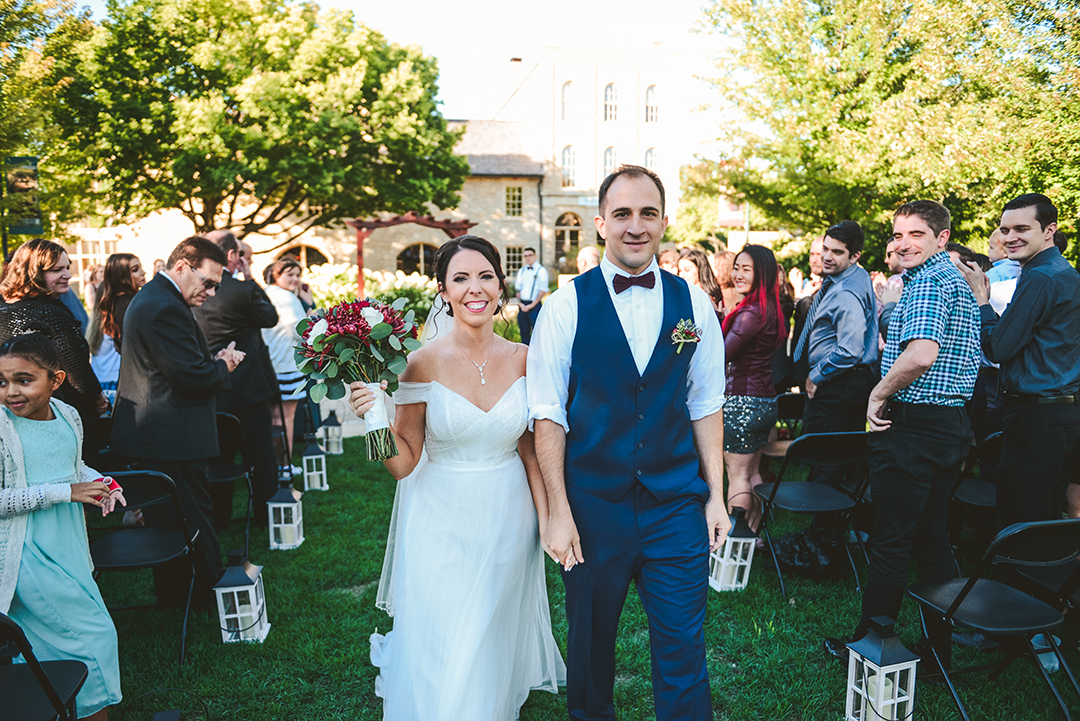 the bride and groom walking down the aisle after just getting married in Lockport IL