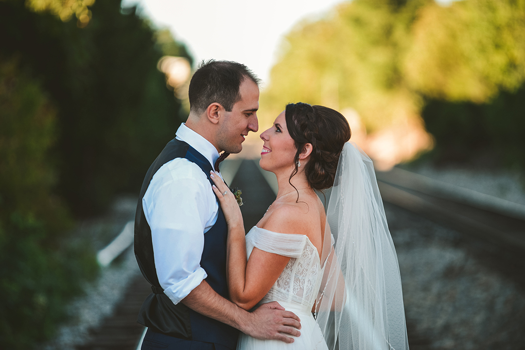 a bride and groom looking into each others eyes after getting married at a historic building in Lockport