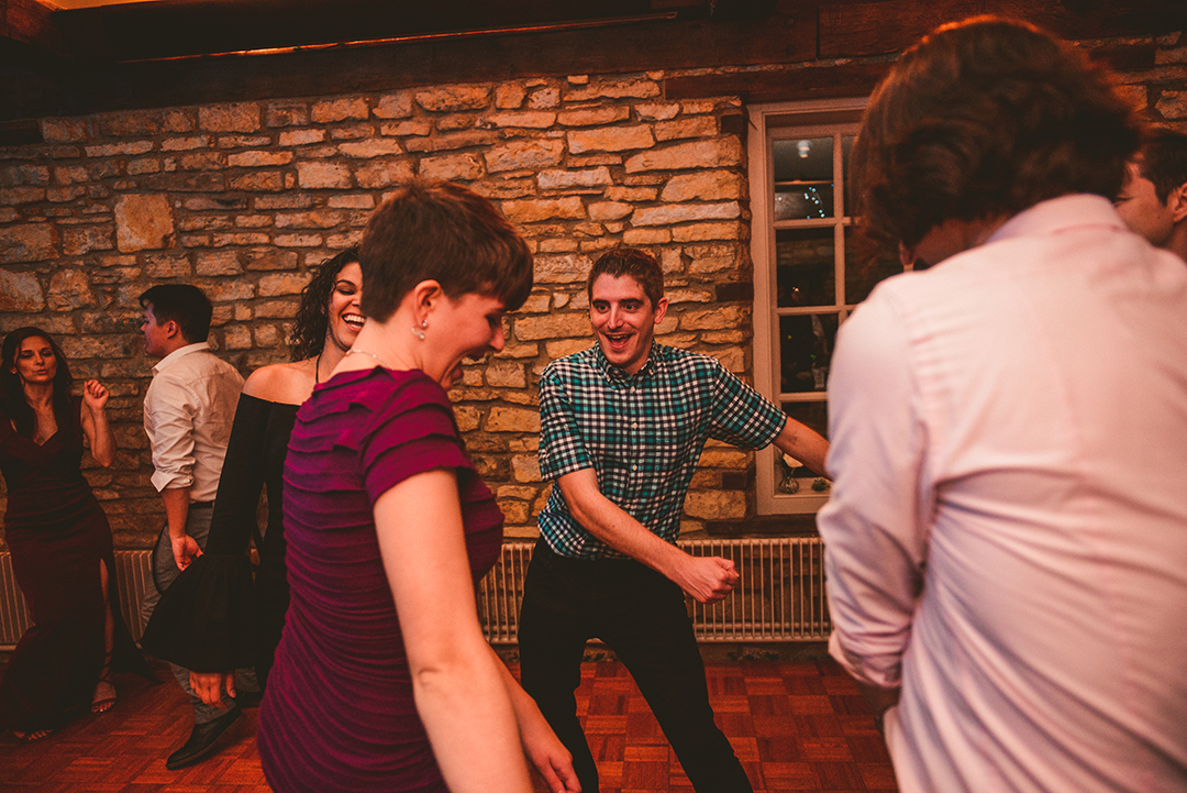 a group of wedding guests dancing at a Lockport wedding reception in a old brick historic building