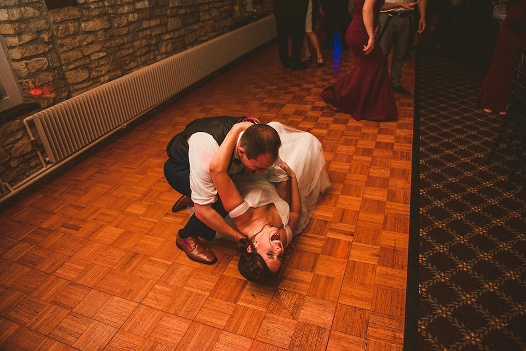 a groom catching his bride as she fell after a dip at a wedding in Lockport IL