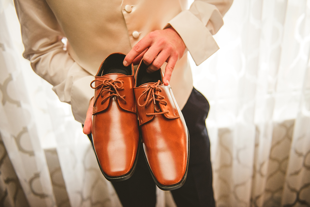 the grooms shoes as he gets ready to get married at St Thomas Apostle Church in Naperville