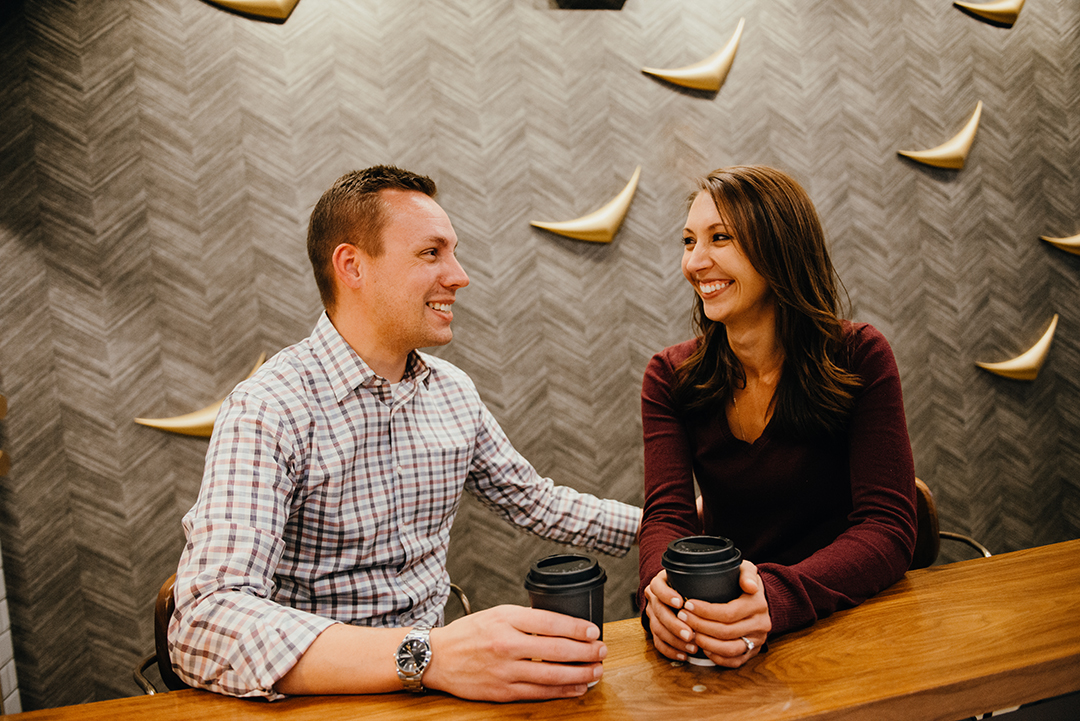 a bride and a woman sitting at Sparrow Coffee in Naperville as they drink coffee and get warm