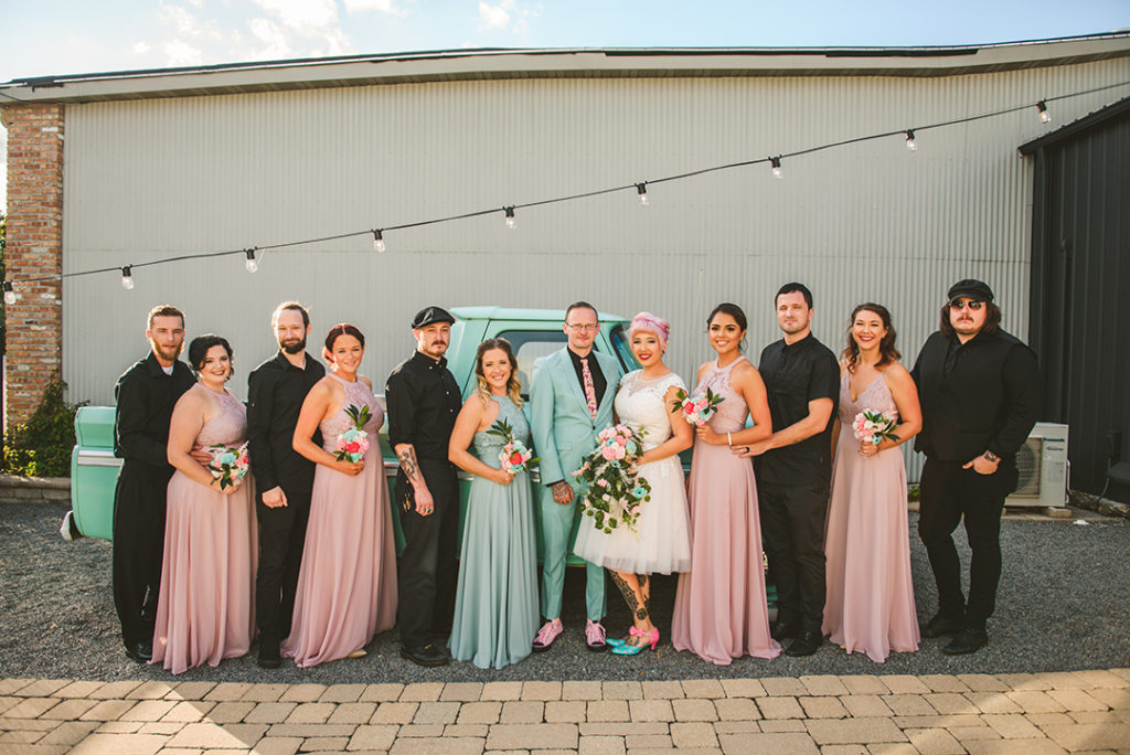 a bridal party standing in front of a vintage truck at the Warehouse 109 in Plainfield IL
