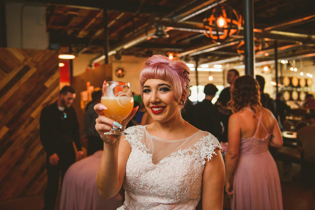 a tattooed bride holding up her beer at Werkforce Brewing in Plainfield IL