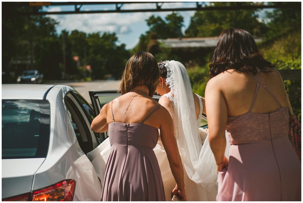 a behind the scenes look of a bride getting into a car before her lake wedding in Lake Bloomington Illinois