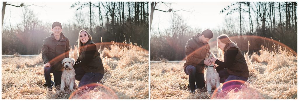 Rustic Engagement Photos of a bride and groom playing with their dog in a field with a beautiful lens flair
