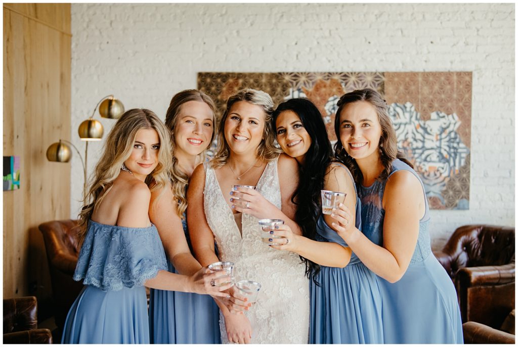 a group of bridesmaids having a toast and laughing at Society 57 in Aurora