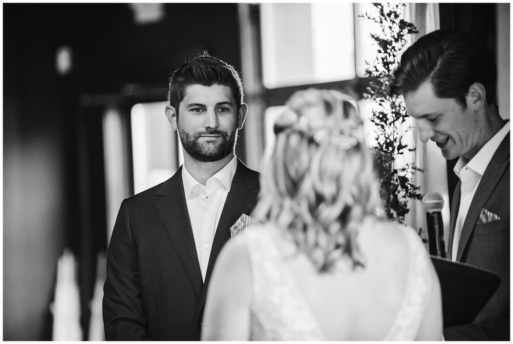 the groom smiling as he looks at his bride during their wedding at Society 57 in Aurora IL