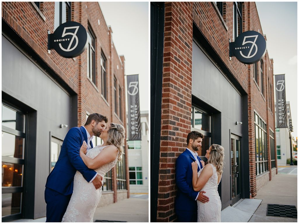 the bride and groom kissing in front of Society 57 in Aurora as the sun sets in the sky