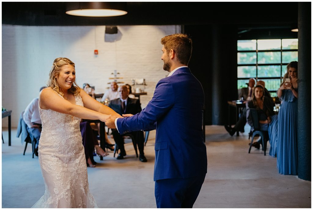 the groom swinging his bride during their first dance at Society 57