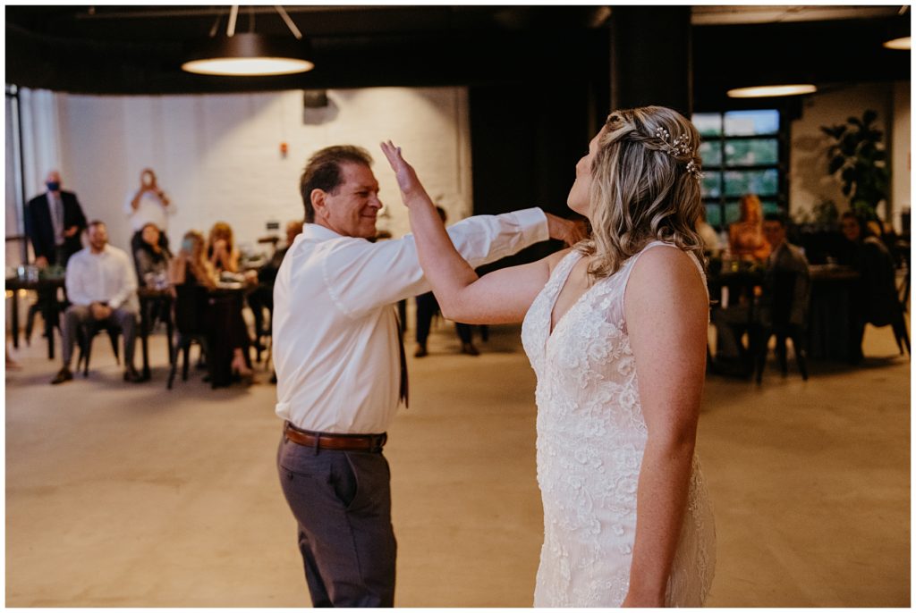 the bride and her father giving each other 5 during a choreographed dance at a wedding reception at Society 57