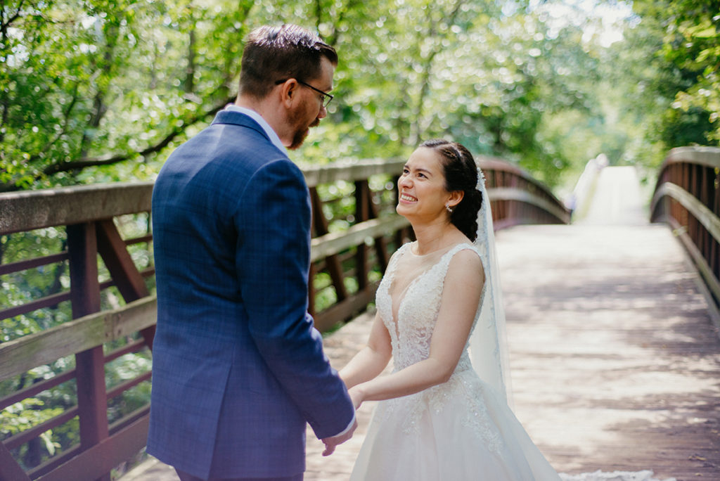 a beautiful thai bride seeing her groom for the first time on a historic bike trail