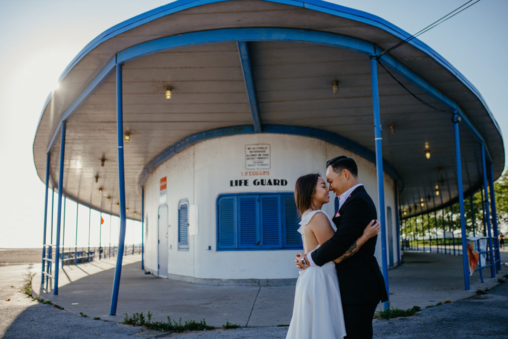 a bride and groom standing close together at their sunrise engagement session