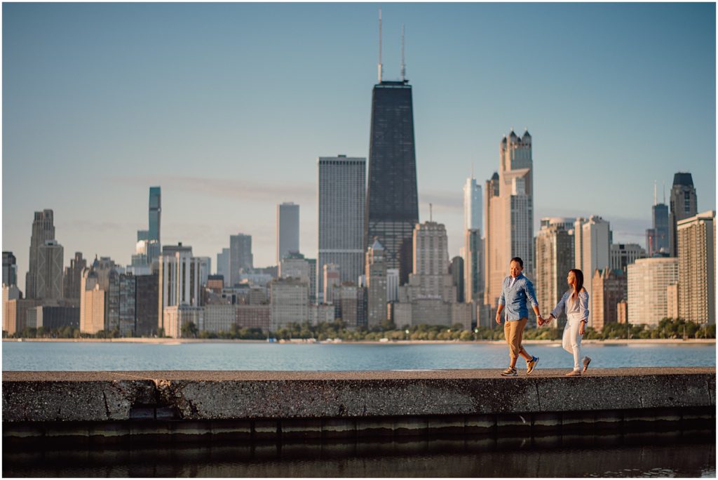 an engaged couple walking together at their North Avenue Beach sunrise engagement session