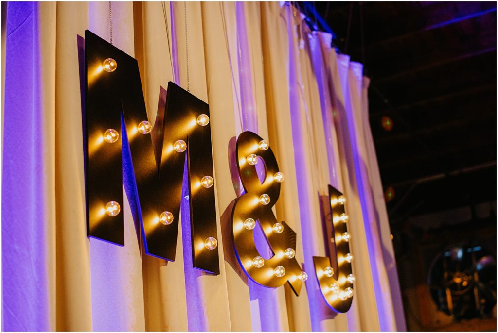 M & J letters lit up for a warehouse wedding in the winter