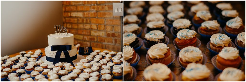 the wedding cake and cup cakes in front of an old brick wall at a warehouse wedding