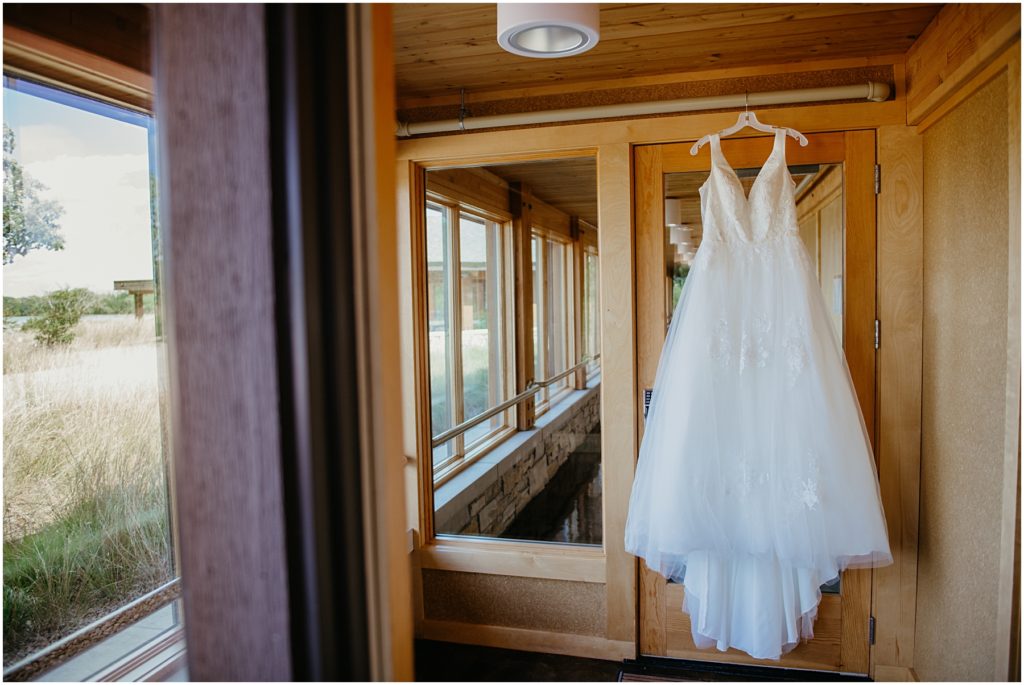 a wedding dress hanging at the Four Rivers Environmental Center at an intimate wedding