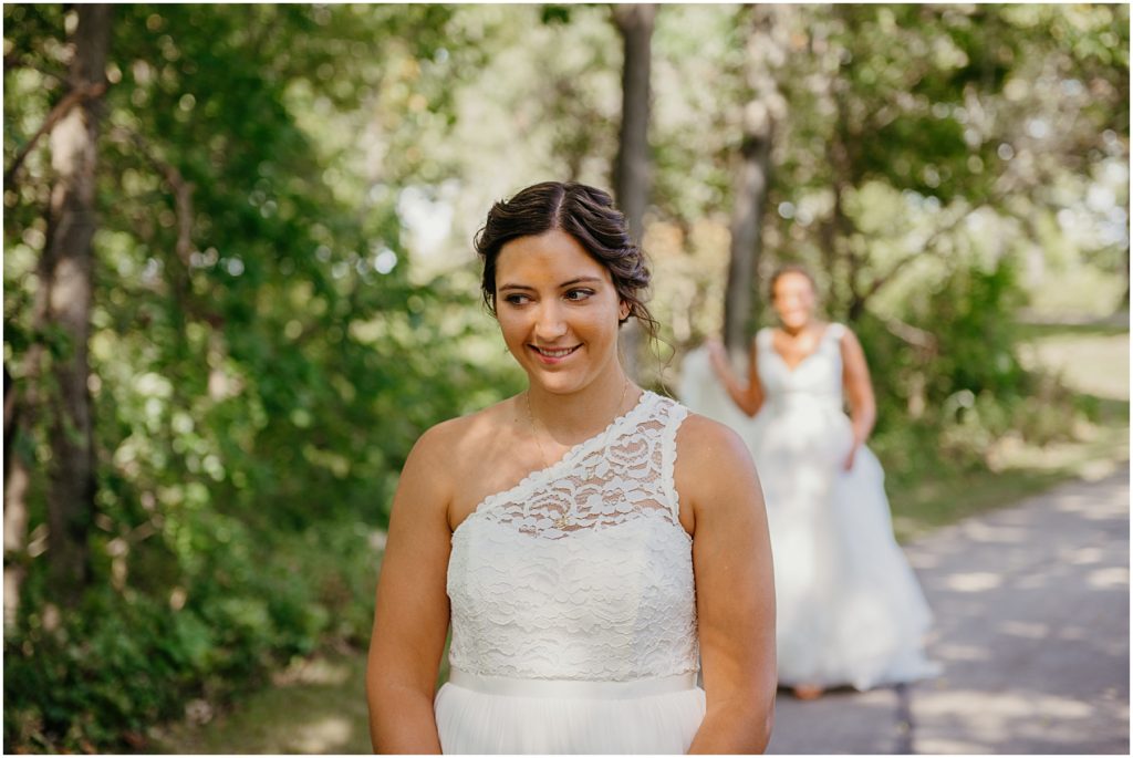 a bride biting her lip as she waits during her first look at her intimate wedding