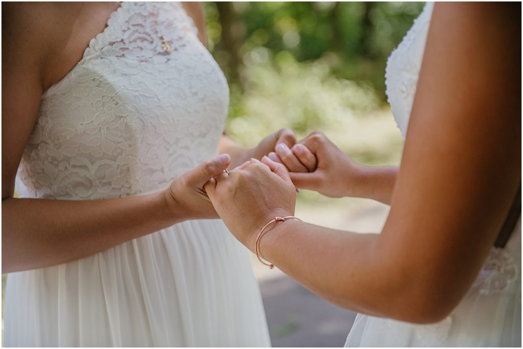 two brides holding hands during their first look at their intimate wedding