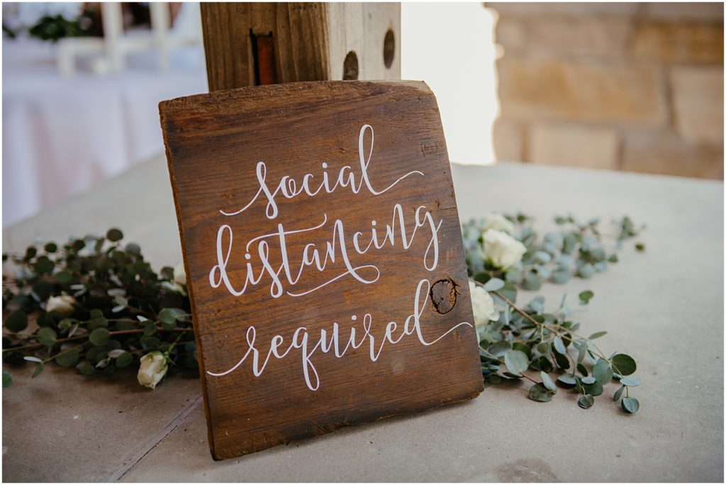 social distancing required sign at a intimate wedding during COVID