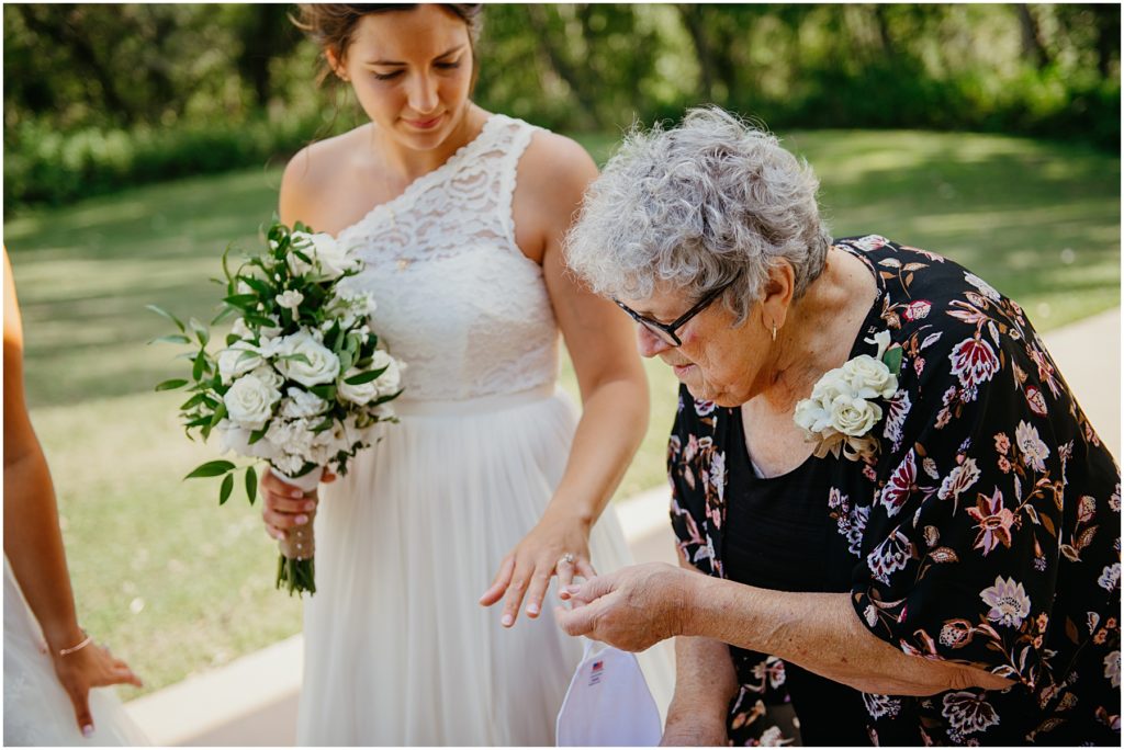 the grandmother of the bride looking at the brides wedding ring during an intimate wedding