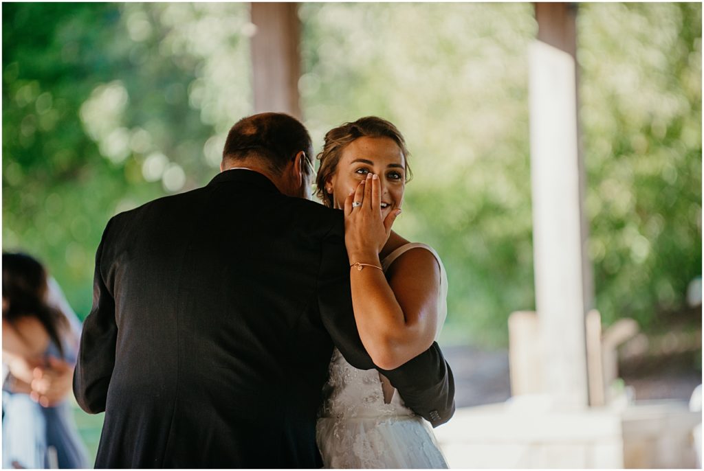 the bride whipping a tear during the father daughter dance at an intimate wedding